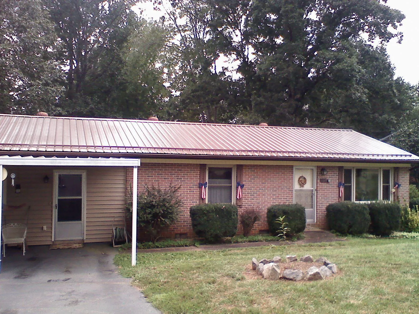 Bronze metal roof and carport on a brick ranch home — Roof Repair work by our crew in Sharon Grove